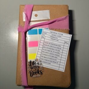 Brown Wrapped Book with Pink Ribbon and Sticky Notes